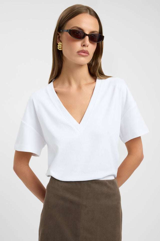 Showcasing the Lani Vee Tee womens blouse in white with relaxed fit, v-neck and short sleeves detail