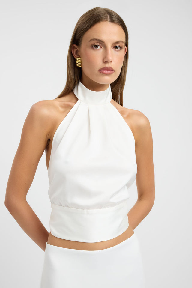 Featuring the Palermo Wrap Top womens blouse in solid ivory with fitted high-neck sleeveless style detail