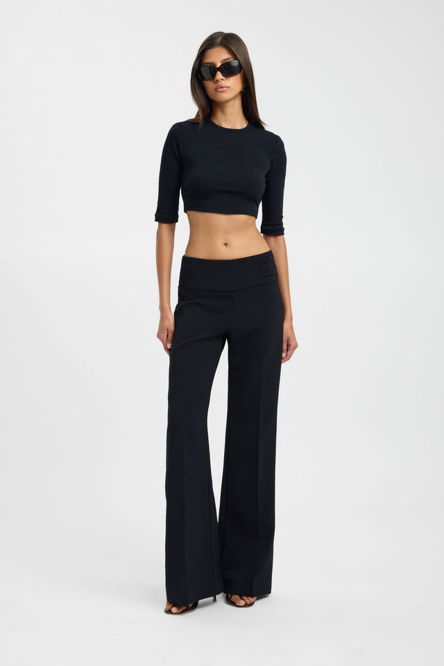 Showcasing the Nancy Crop womens blouse in black with fitted silhouette and round neckline featuring three-fourth sleeves on-body