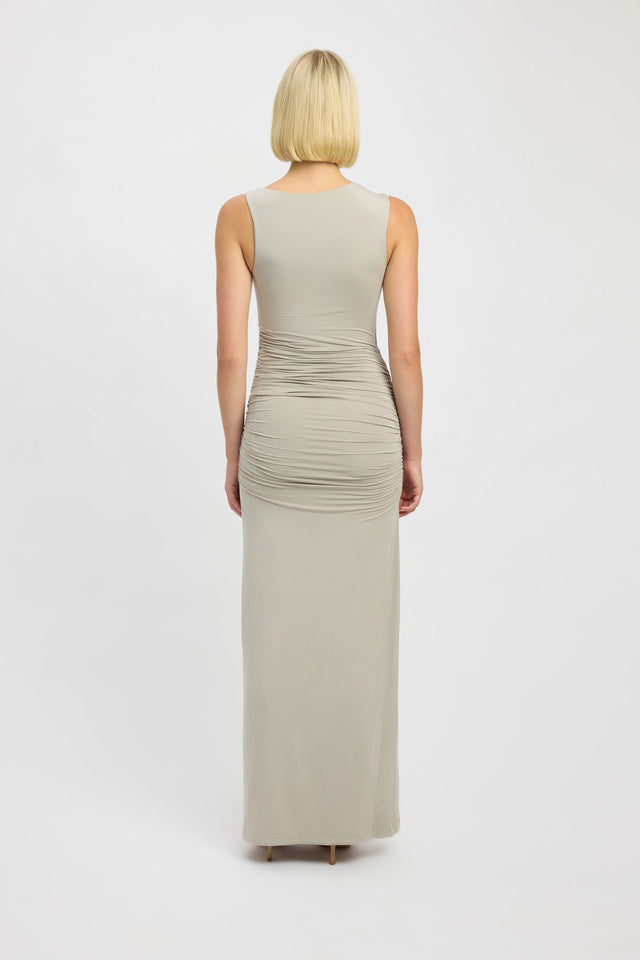 Back profile of sleeveless light green maxi dress with rouching on waist.